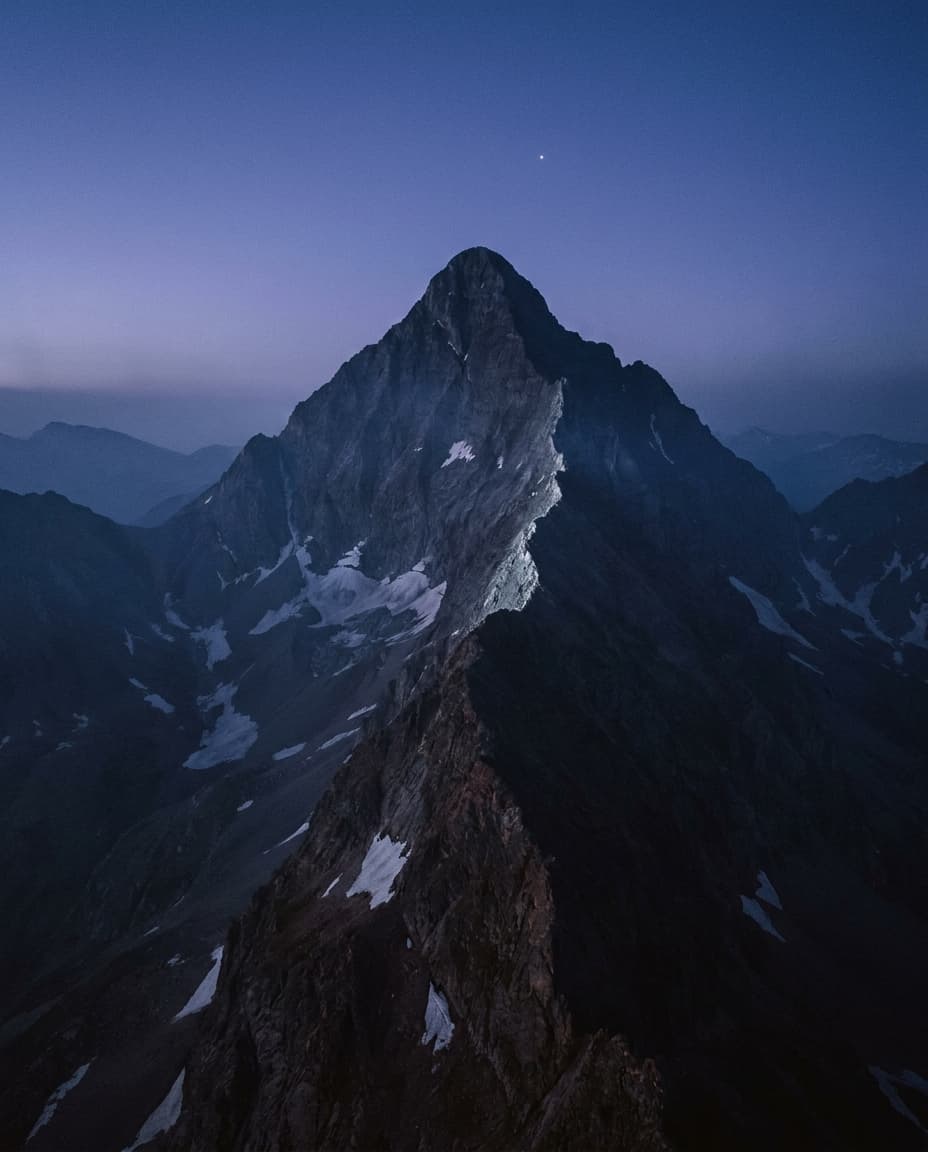 Capitol Peak in deep blue-hour pre-dawn light, vertical alpine composition