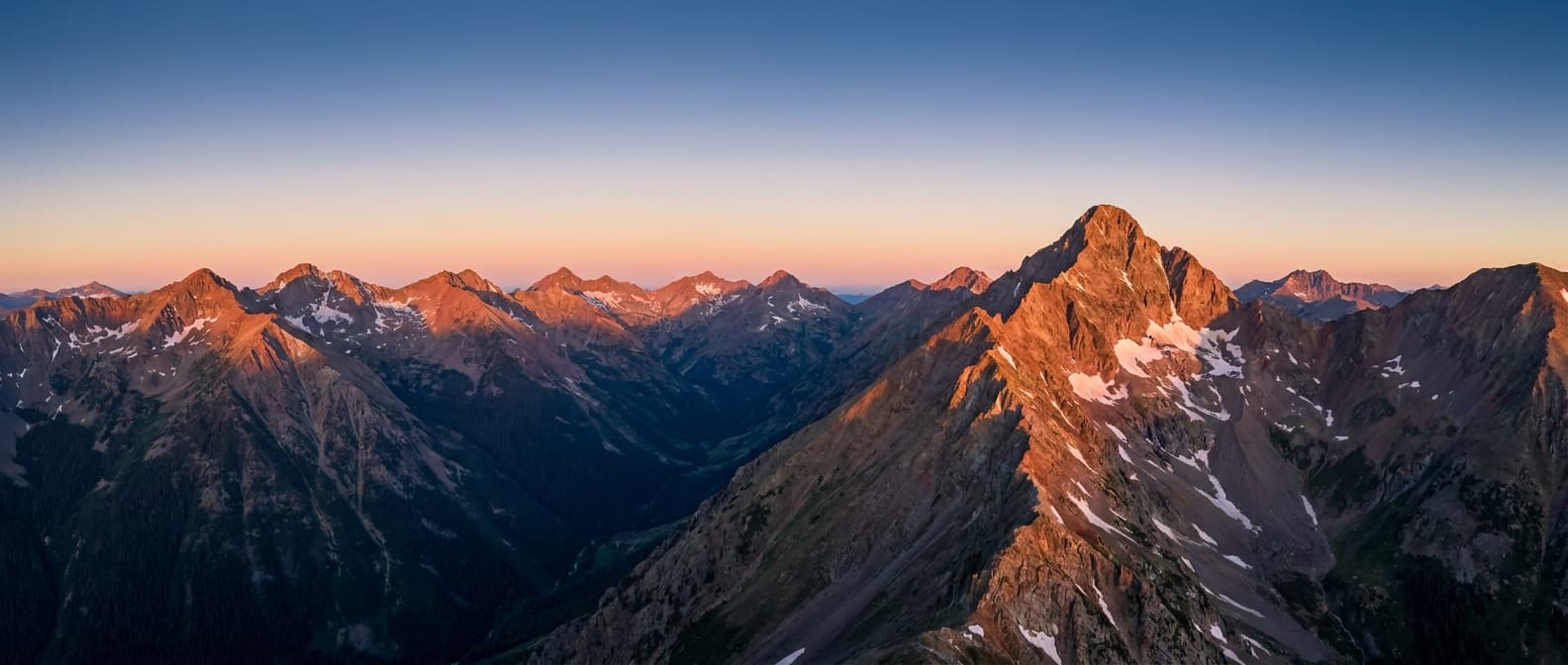 Wide Rocky Mountain Elk Range panorama at sunrise with Capitol Peak prominent