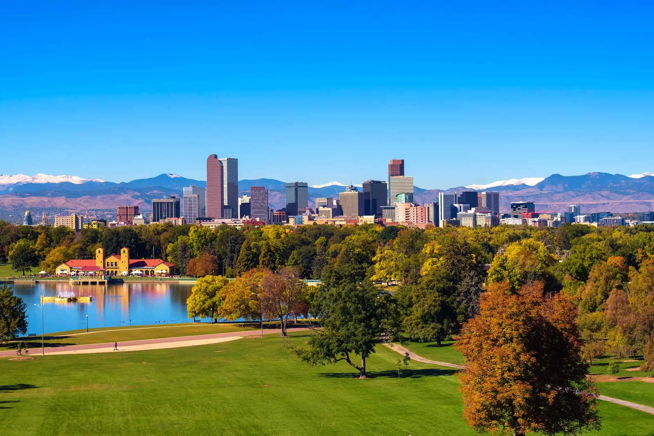 Scenic view of Washington Park and the Denver, Colorado skyline with snowcapped mountains in the background - Header banner for Illumine Legal LLC law firm homepage