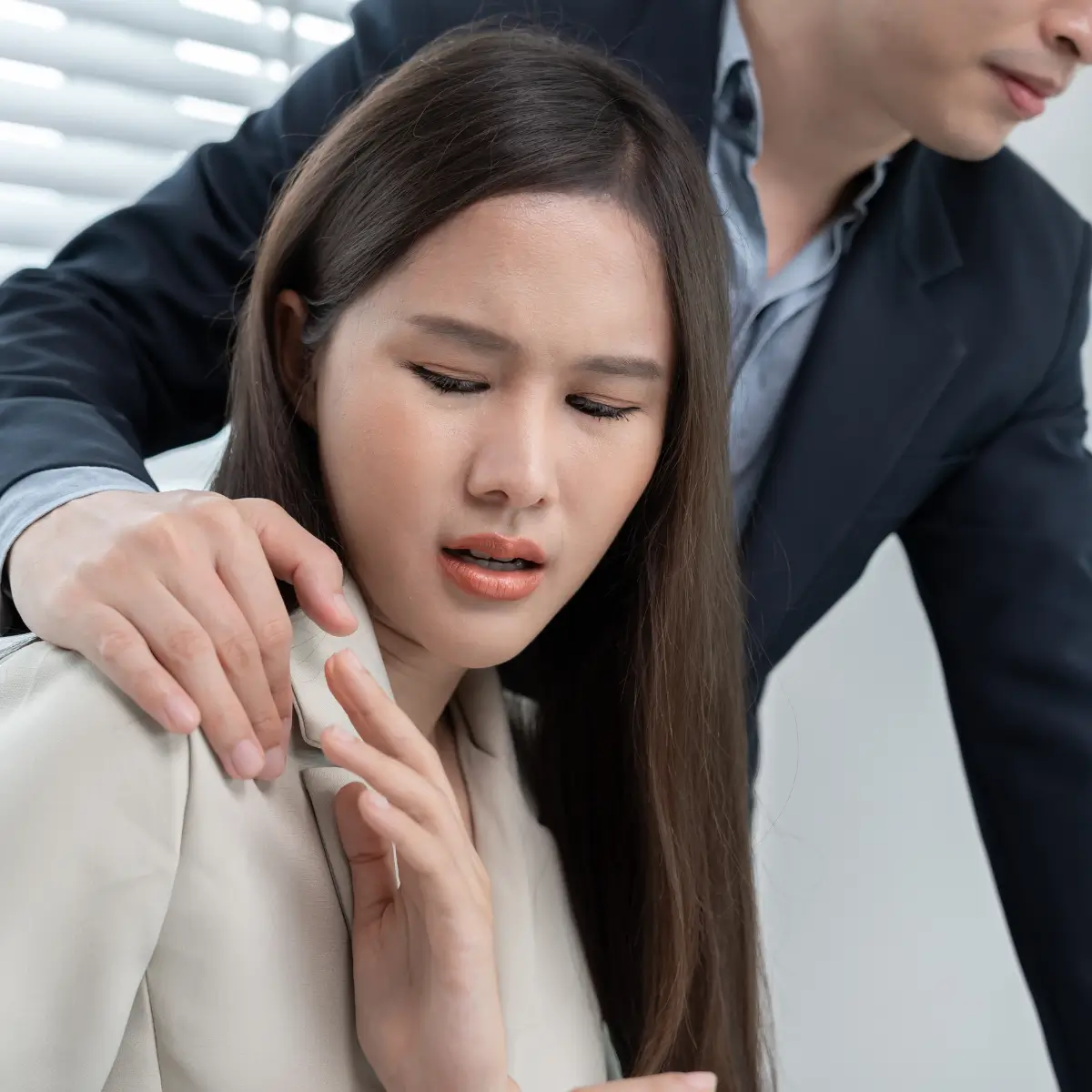 Woman being sexually harassed in her workplace