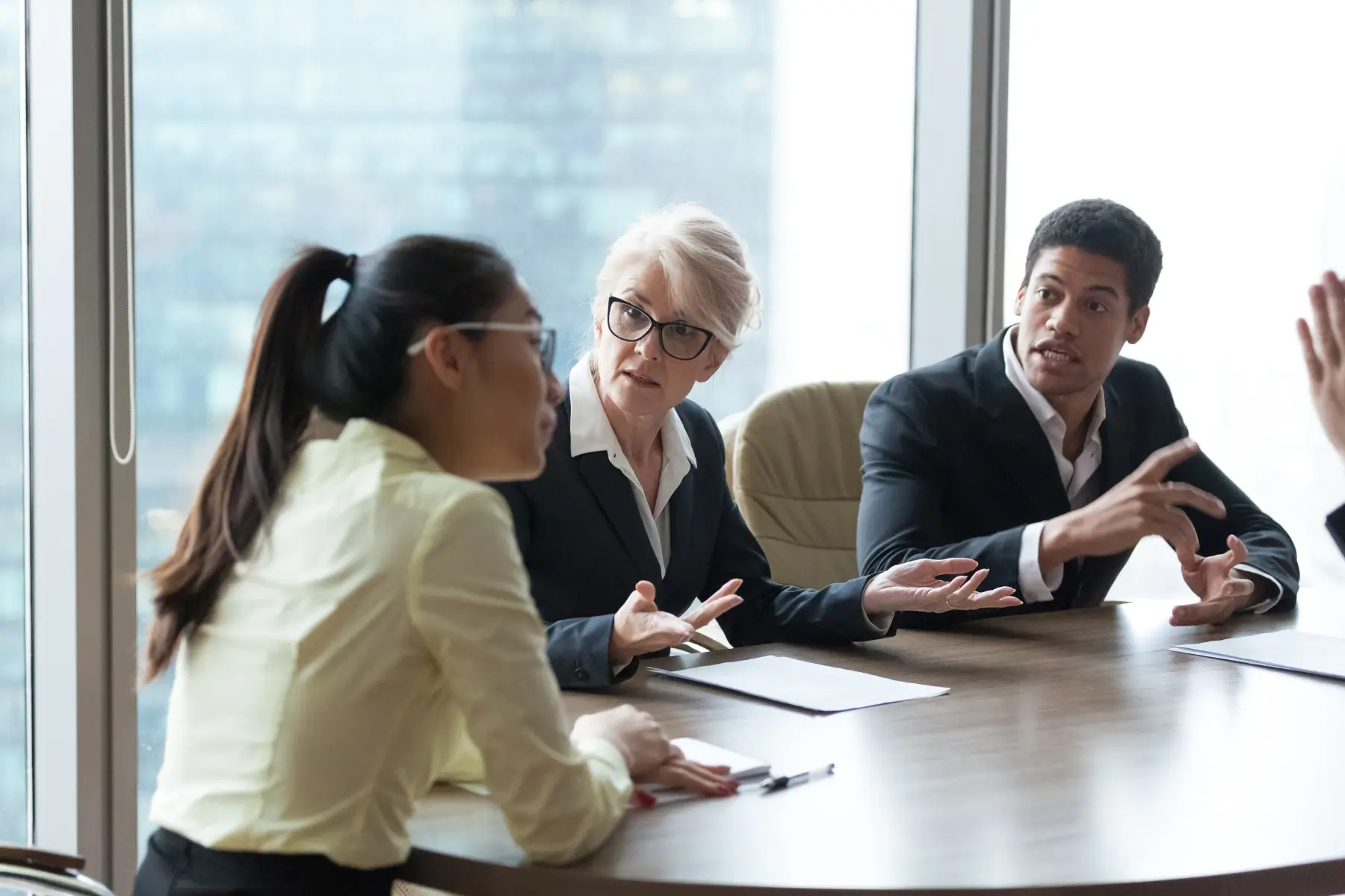 Business Partners Sitting at a Table Having a Corporate and Commercial Transaction Dispute