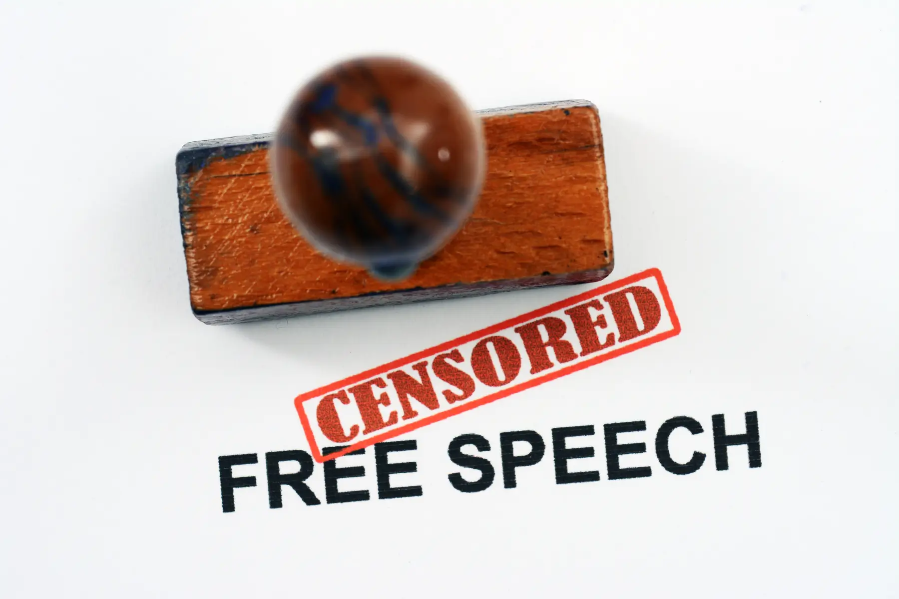 The word censored stamped over free speech to represent a first amendment violation