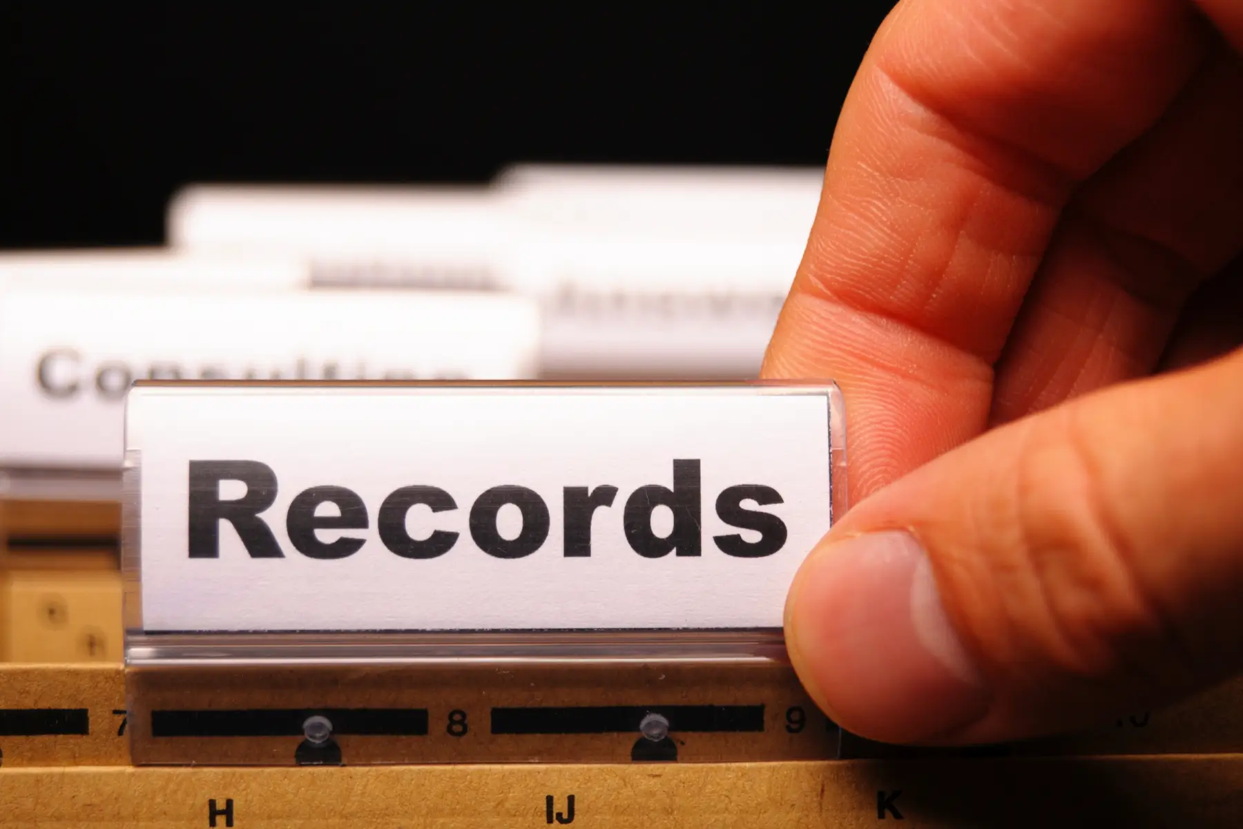 Hand looking through government records